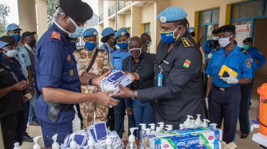 UN Police in the DRC donate personal protective equipment to fight COVID-19 police handing over face masks and hand sanitizer