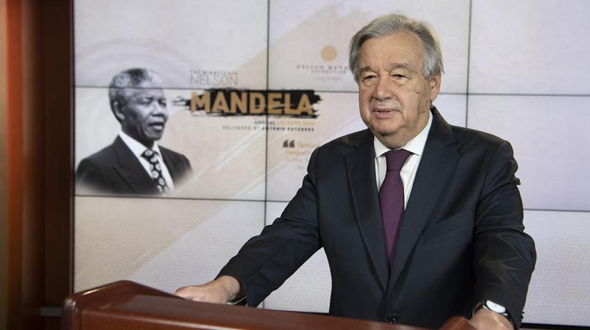 Secretary-General António Guterres at podium with Nelson Mandela portrait in the background