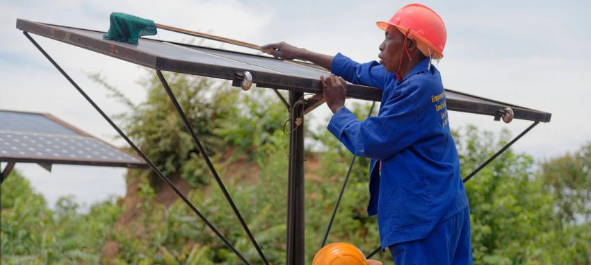 worker cleaning solar panels