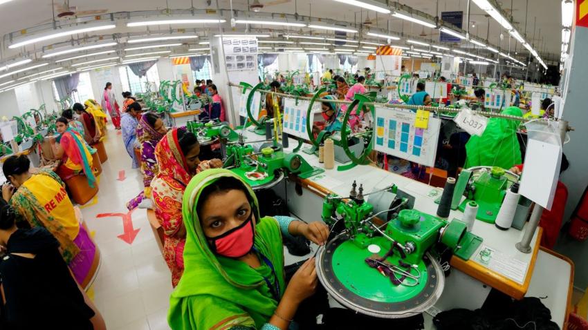 Women working on the production floor of a textile factory in South Asia.