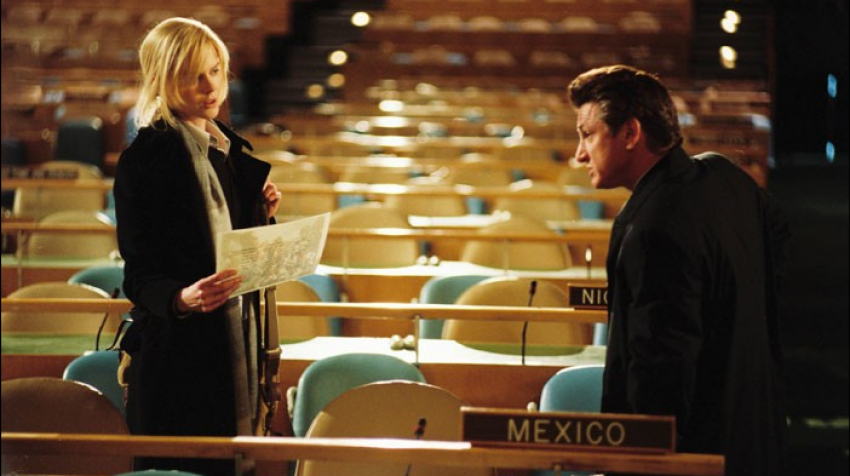 Woman and man sitting on the tables in the General Assembly Hall. 