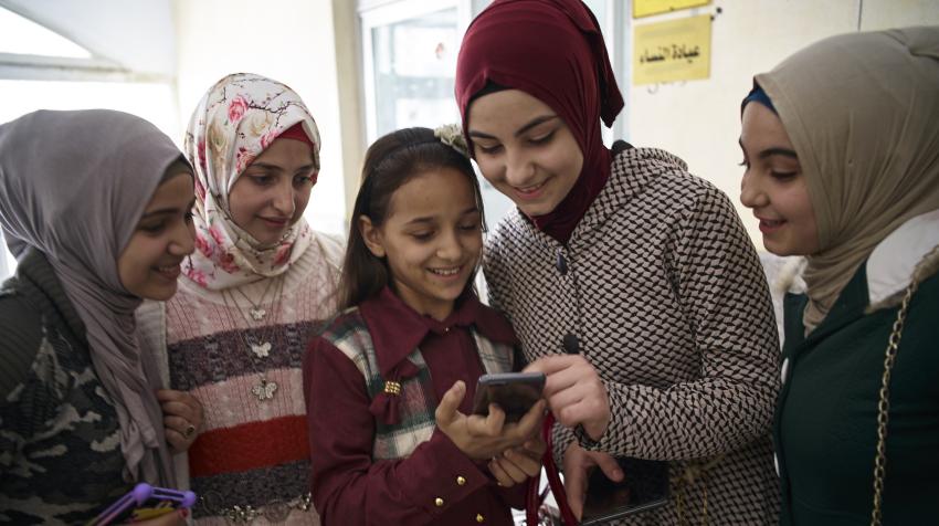 Syrian children use a smart phone outside a Technology Room designed to provide children with a creative learning experience at New Damietta Primary Health Centre in Damietta Governorate, Egypt, 2017. ©UNICEF/UN0212339/Shehzad Noorani