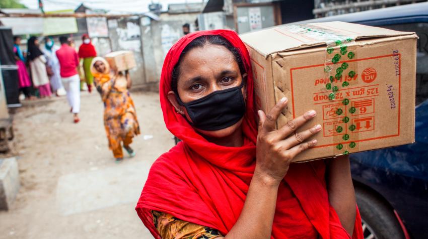 women carrying boxes of emergency supplies