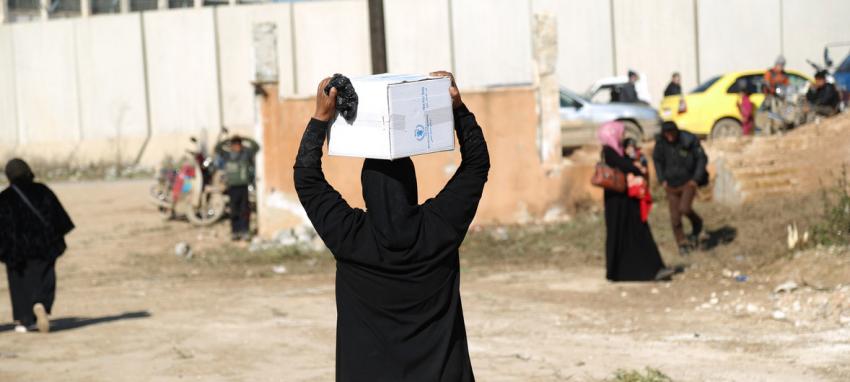 woman carrying WFP box on her head