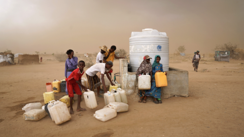 IDPs collect water during a brewing sandstorm. Water is heavily rationed and only available during one-hour windows, which normally take place just three times a day.