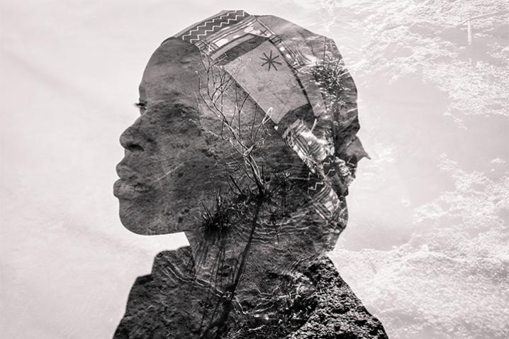 Superimposed image of a profile of a woman against the texture of the earth