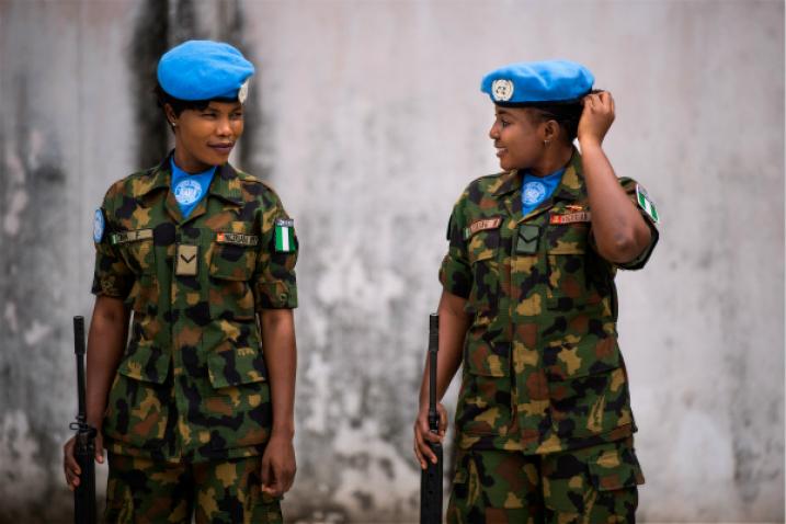 Two Nigerian peackeepers await an inspection of their base.