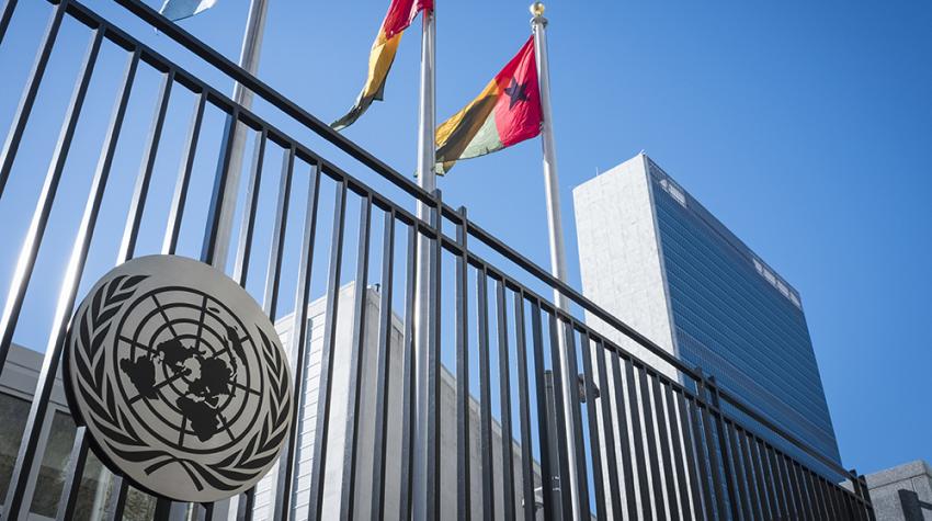 A view of the United Nations Secretariat Headquarters Building and the flags of UN member states on First Avenue in New York City.