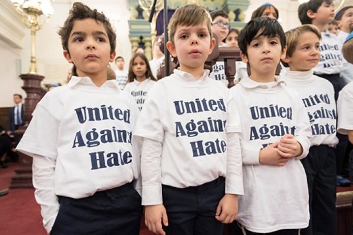 Boys wearing t-shirts that read: "United Against Hate"