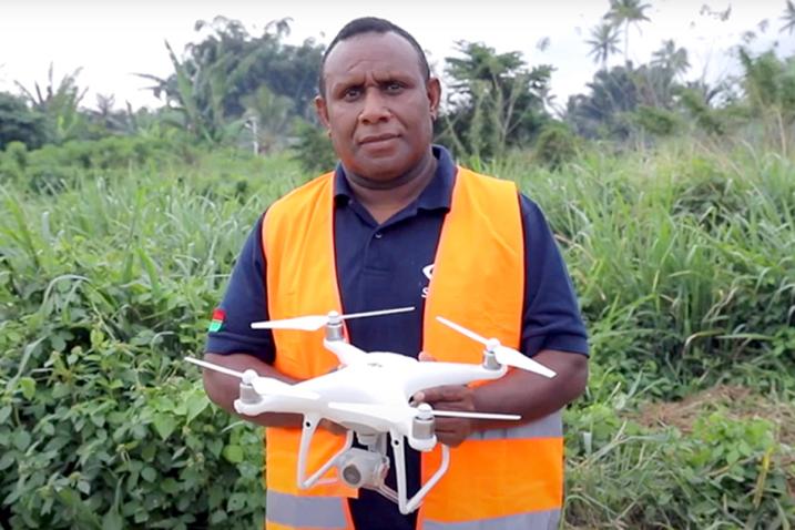 A man holding a drone.