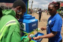 : A woman uses one of the hand-washing facilities installed by the United Nations Human Settlements Programme (UN-Habitat) in Nairobi’s Kibera slum. © UN-Habitat/Julius Mwelu