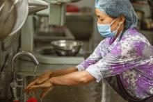 Tshering washes her hands before starting work at Chuniding Foods in Thimphu, Bhutan, 10 August 2023. WHO / Sue Price 