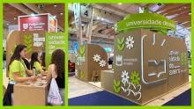 Two photos of the University of Aveiro’s eco-designed booth at an indoor education fair. The stand is made of cardboard with green and white floral graphics and the university’s logo. In one image, student representatives speak with visitors at an informa