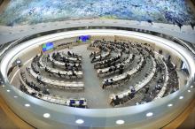 Birds eye view of a large circular conference room with concentric circles of desks