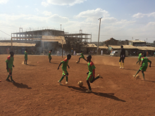 Children play football at the ACAKORO Football Academy in the Korogocho section of Nairobi, Kenya, September 2015. © UNOSDP