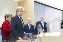 Secretary-General António Guterres standing at podium with other UN officials behind him.
