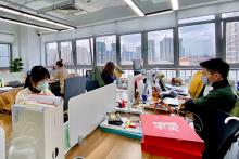People wearing face masks inside an office.
