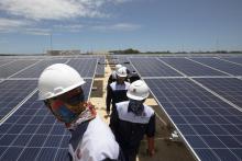 workers on solar panel roof