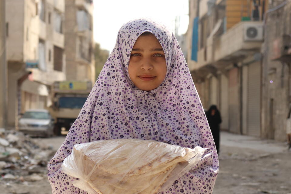Syrian girl holding bread