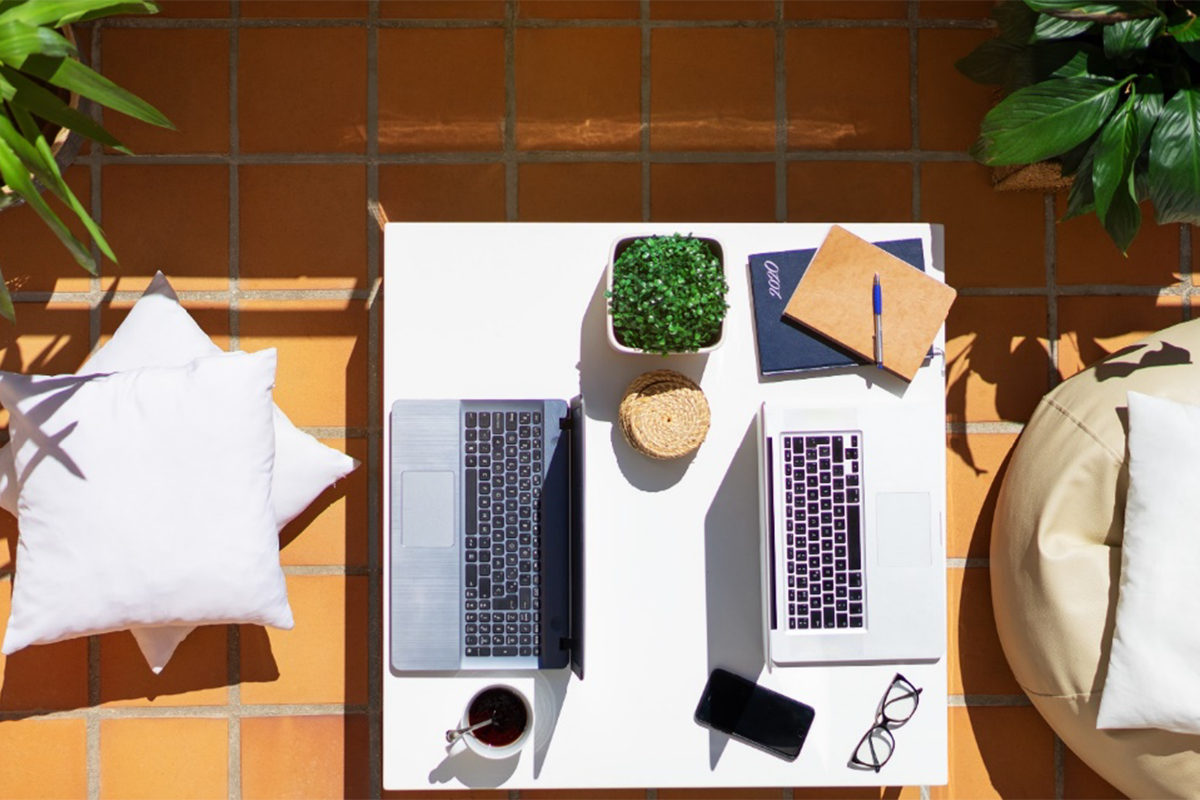 A view from above of two laptops set up in an outdoor space.