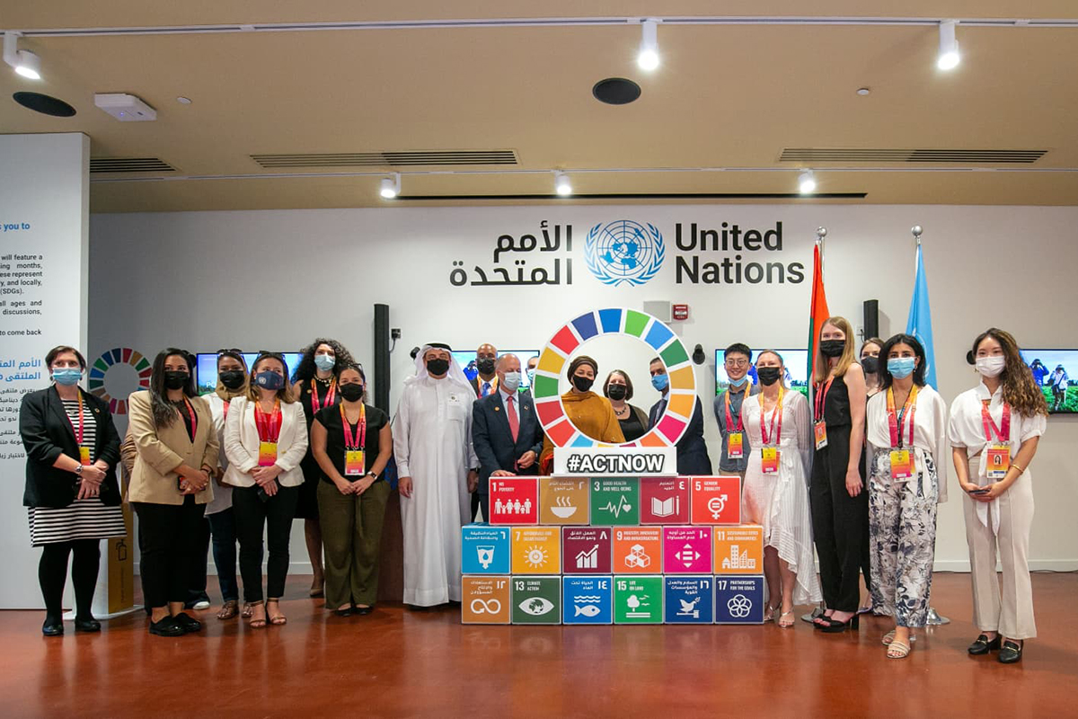 UN officials pose in front of SDG posters