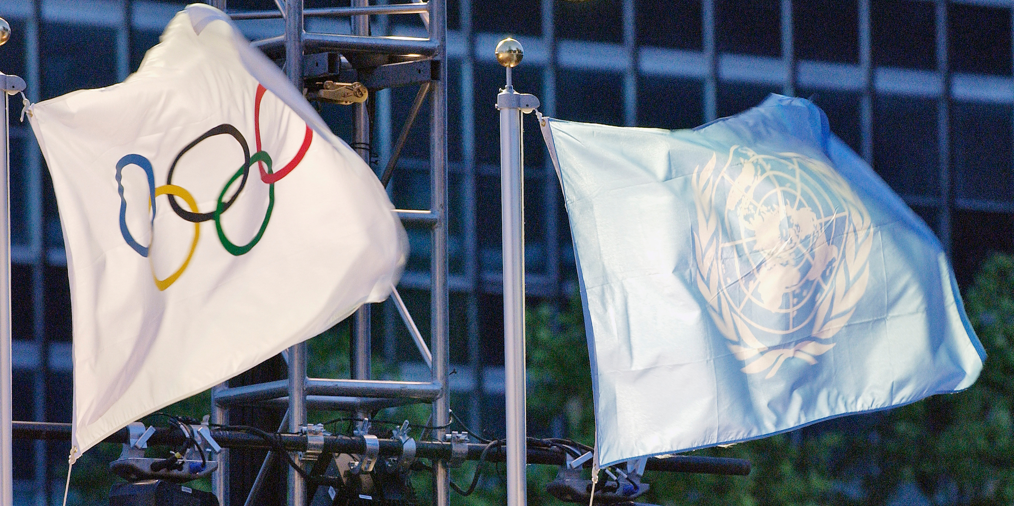 The United Nations and the Olympic flags are raised at the UN Headquarters. 