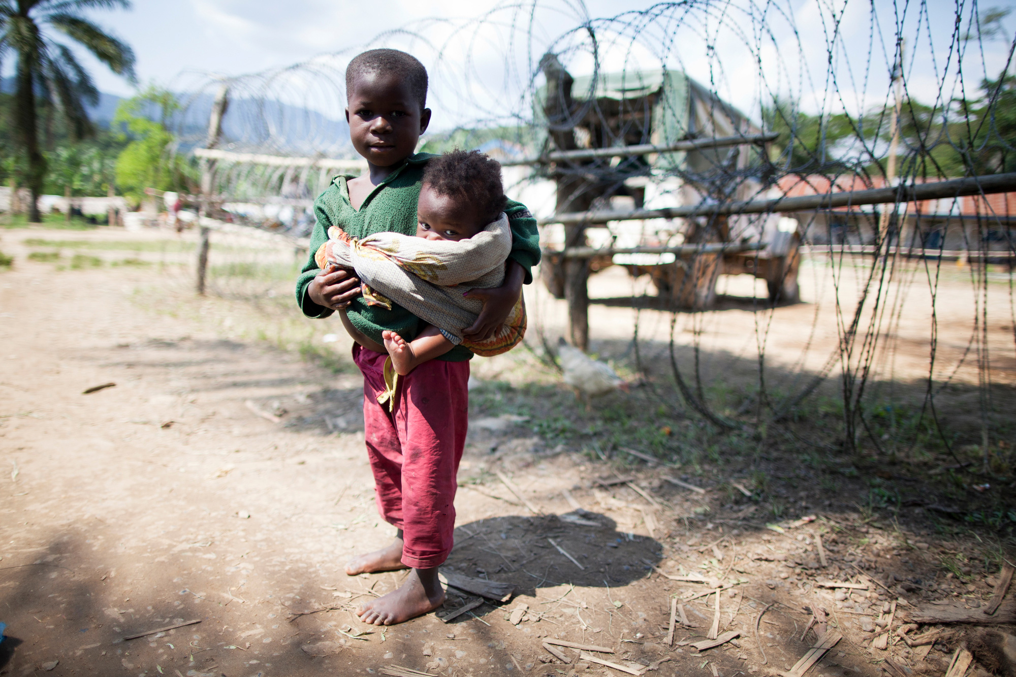 little boy holding baby