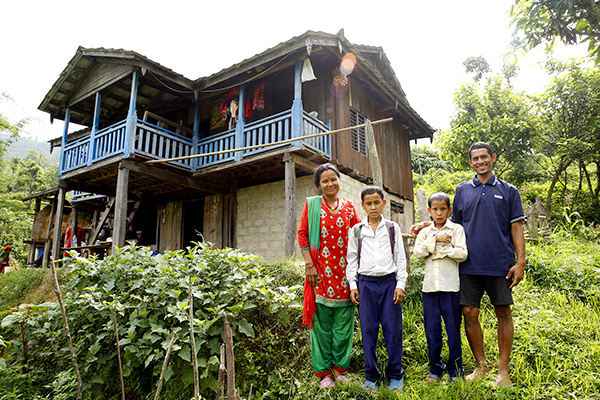 A Nepalese family in front of their house.