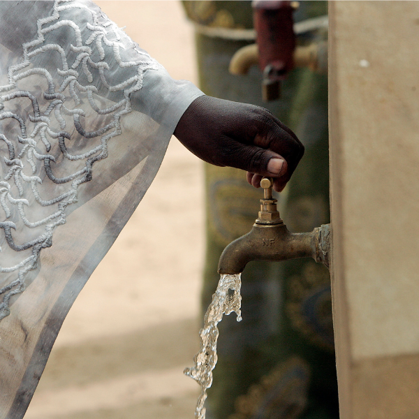 Clean drinking water runs freely from a communal water faucet.