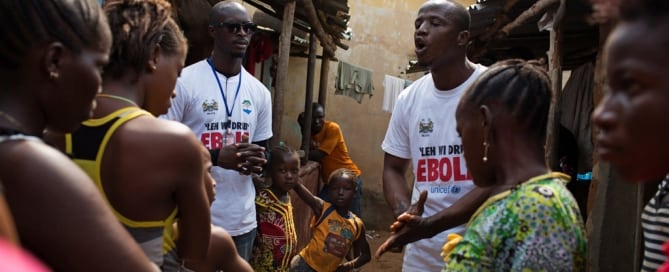 Social mobilizers going door-to-door, speak with residents of a slum in Freetown, the capital of Sierra Leone, in the fight against Ebola
