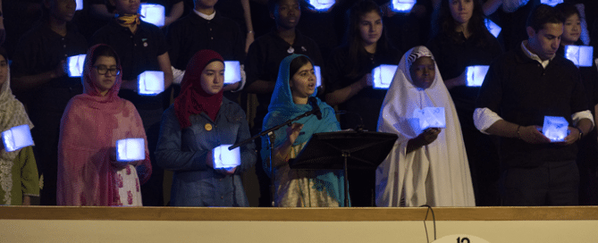 Malala Addresses General Assembly at SDG Summit 2015 Malala Yousafzai (centre), education advocate and Co-founder of the Malala Fund, addresses the General Assembly during the opening day of the UN’s Sustainable Development Summit, taking place in New York from 25-27, September, 2015. She is joined by youth from all 193 Member States holding solar-powerd lanterns that represent the youth's hope for the future and committment to help meet the Global Goals set down in the Summit's agenda, "Transforming our world: the 2030 Agenda for Sustainable Development". UN Photo: Mark Garten