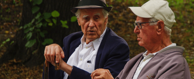 Two elderly retirees chat on park bench. Photo: World Bank/Celine Ferre