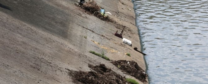 Photo: In Pasig, Philippines, a city worker cleans the Manggahan Floodway, built to reduce flooding along the Pasig River during the rainy season.