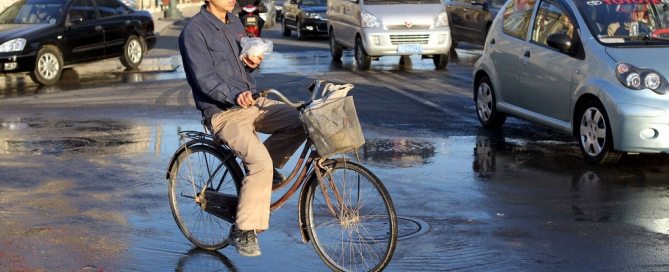 A migrant worker on his bicycle in Tianjin, China.