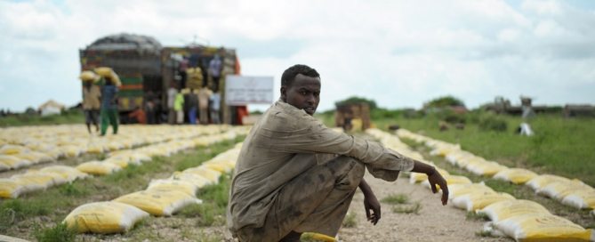 Photo: A man rests on a bag of rice distributed by Qatar Charity for iternally displaced people (IDPs) affected by flooding and clan conflict in Jowhar, Somalia.