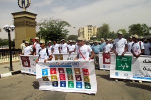 Participants at an SDG event in Aswan, Egypt, hold an SDG banner.