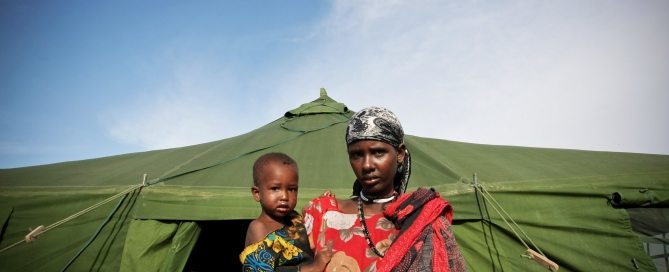 Photo: A Somali woman and a malnourished child exit from the medical tent after the child receives emergency medical treatment from the African Union Mission in Somalia (AMISOM), an active regional peacekeeping mission operated by the African Union with the approval of the United Nations. Somalia is the country worst affected by a severe drought that has ravaged large swaths of the Horn of Africa, leaving an estimated 11 million people in need of humanitarian assistance. UN Photo/Stuart Price.