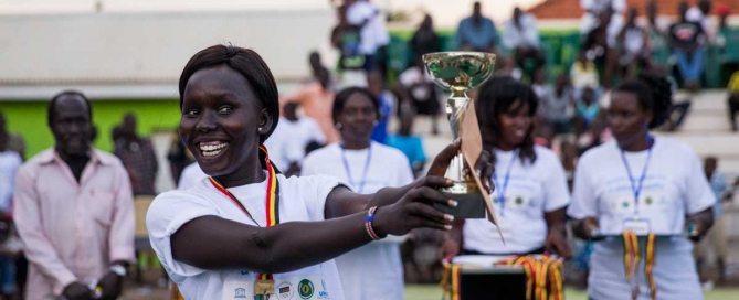 Photo: A young woman from a volleyball team poses with her medal at a special event held today in Juba, South Sudan, in celebration of the International Day of Sports for Development and Peace.