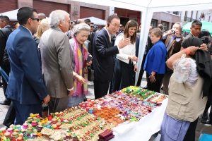 Photo: Mr. Ban greets a vendor selling crafts.