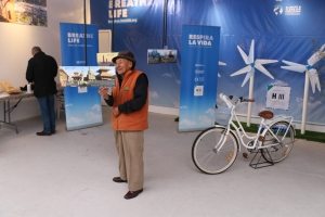 Photo: A man checks out a sustainable energy exhibit in the One UN Pavilion.
