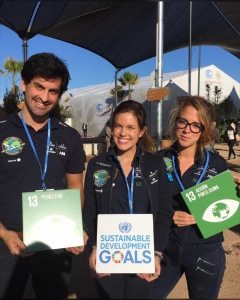 Photo: Members of the Solar Impulse​ solar airplane team take a moment for climate action.