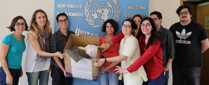 UN Staff in Rio holding donated clothes.