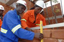 Construction workers at the site of the green homes project in Zambia. 