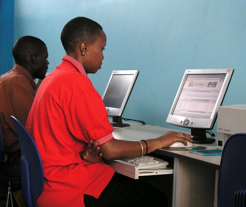 People using computers in an internet cafe in Kampala, Uganda.