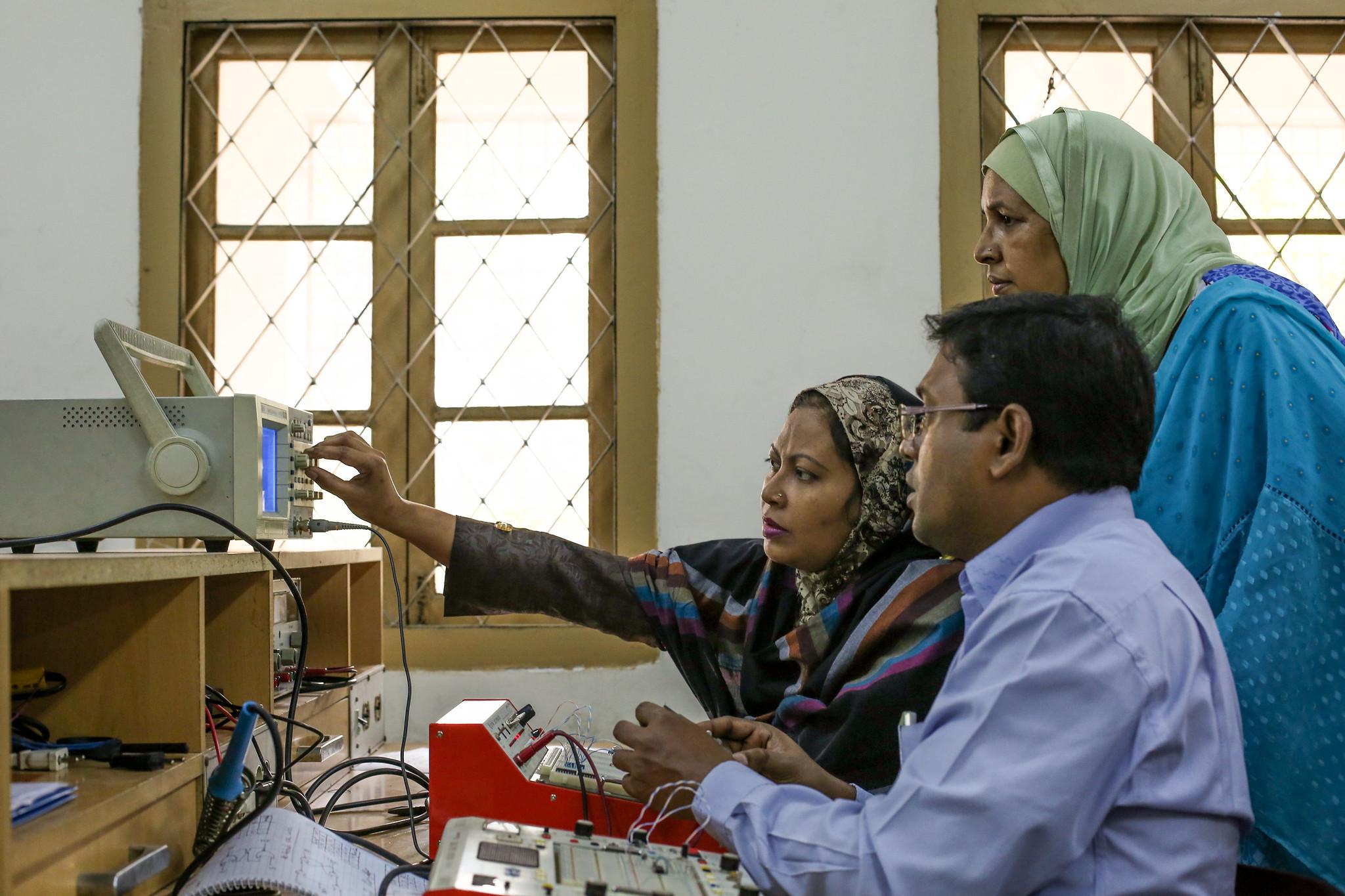 Teacher instructs trainees in a course on electronics in Bangladesh. 