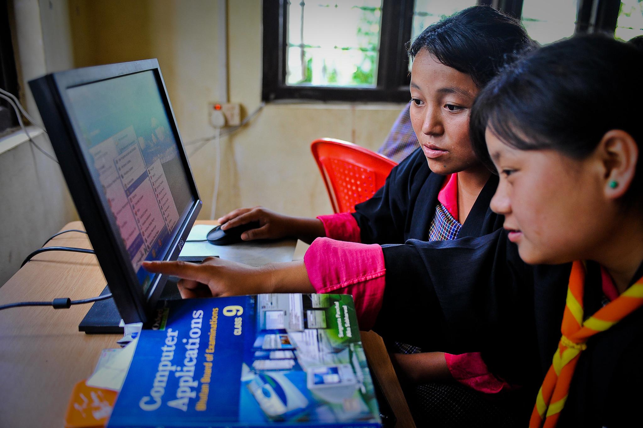Students acquire computer skills and programming at the community e-Center in Bhutan. Students acquire computer skills and programming at the community e-Center in Bhutan.