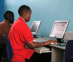 People using computers in an internet cafe in Kampala, Uganda. 