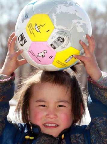 A child playing with an MDG ball.