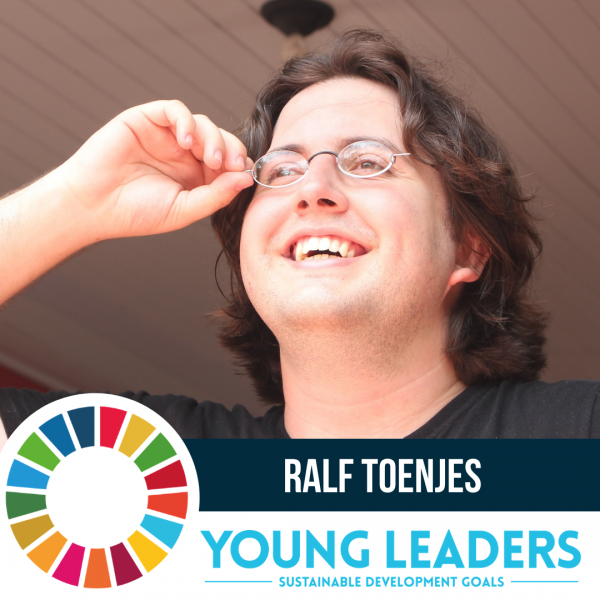 Young man with brown hair touches his glasses as he looks off screen to the right next to a logo and the text "Ralf Toenjes"