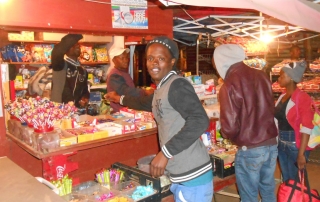 Julius Sematla, pictured, built a successful business from selling candy. Seen here in front of his candy kiosk. Photo/ILO